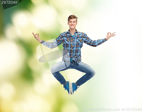 Image of smiling young man jumping in air