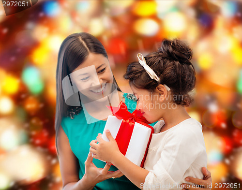 Image of happy mother and little girl with gift box