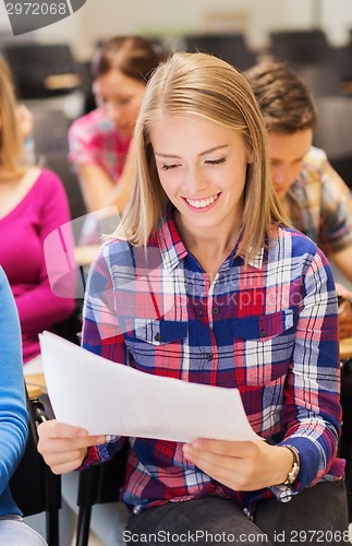 Image of group of smiling students with notebook