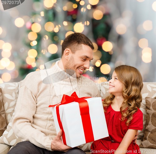 Image of smiling father and daughter with gift box