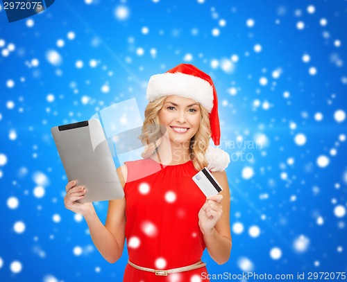 Image of woman in santa hat with tablet pc and credit card