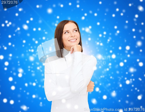 Image of smiling young woman in winter clothes