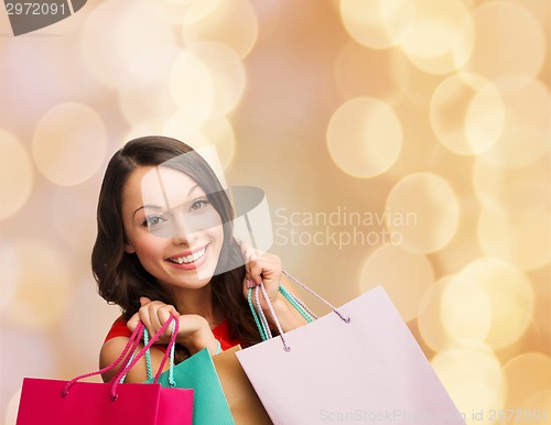 Image of smiling young woman with shopping bags