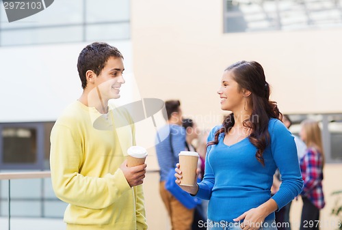 Image of group of smiling students with paper coffee cups