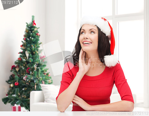 Image of smiling woman in santa helper hat