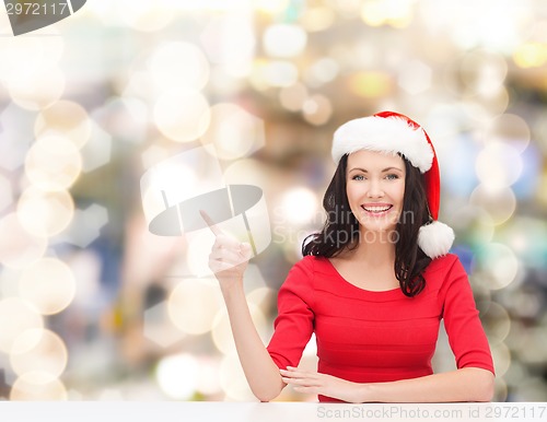 Image of smiling woman in santa helper hat