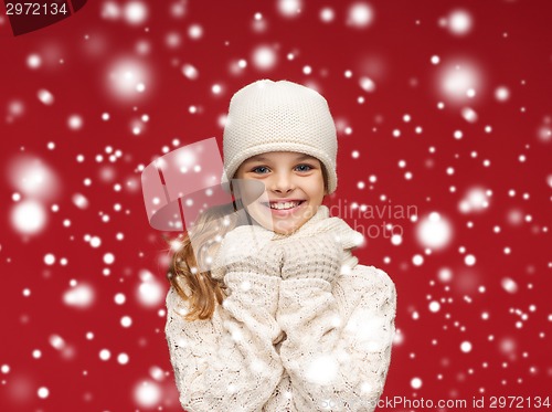 Image of smiling girl in white hat, muffler and gloves