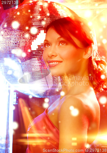 Image of woman in evening dress wearing diamond earrings