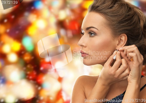 Image of close up of woman wearing earrings