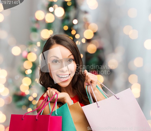 Image of smiling woman with colorful shopping bags