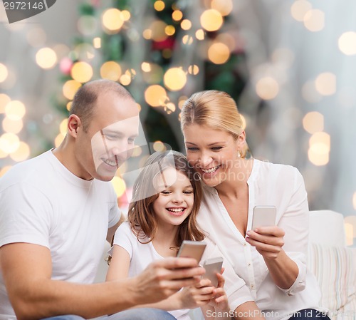 Image of happy family with smartphones