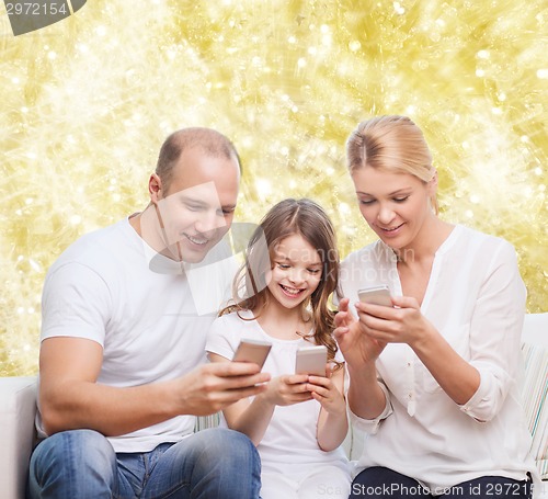 Image of happy family with smartphones