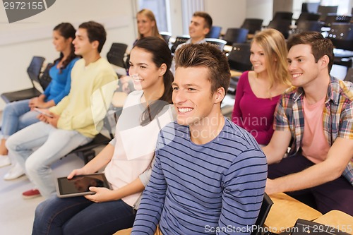 Image of group of smiling students with tablet pc