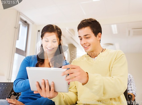 Image of group of smiling students with tablet pc