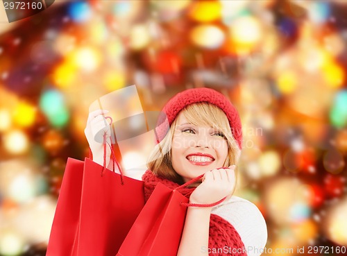Image of smiling young woman with shopping bags