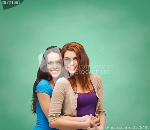 Image of smiling teenage girls hugging