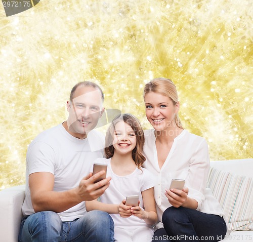 Image of happy family with smartphones