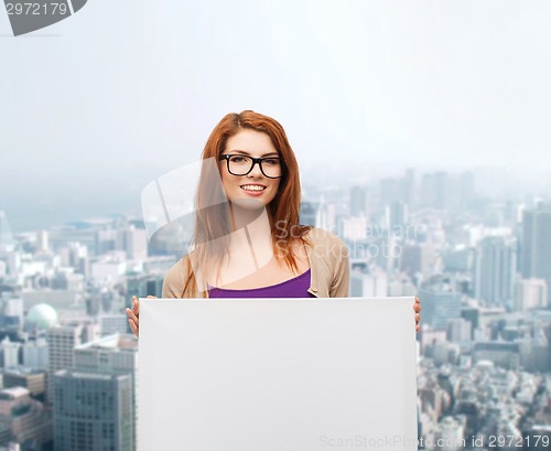 Image of smiling teenage girl in glasses with white board
