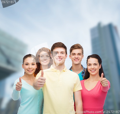 Image of group of smiling teenagers over city background