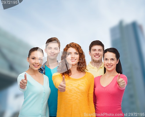 Image of group of smiling teenagers over city background