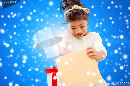 Image of smiling little girl with gift box