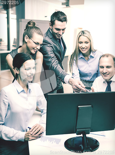 Image of business team with monitor having discussion