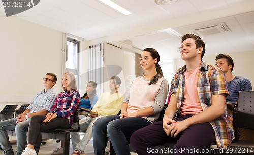 Image of group of smiling students in lecture hall