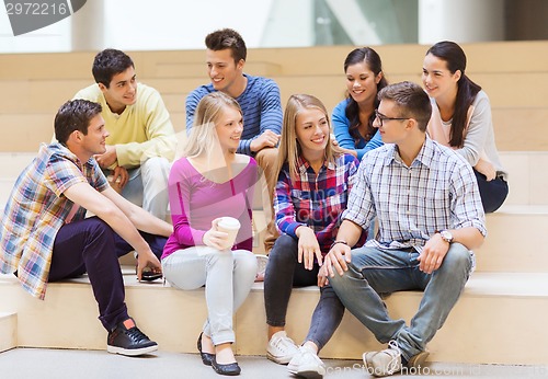 Image of group of smiling students with paper coffee cups