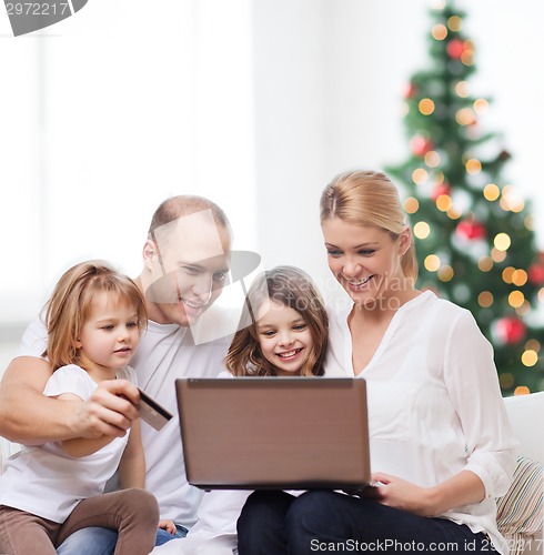 Image of happy family with laptop computer