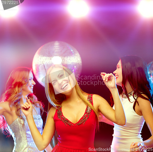 Image of three smiling women dancing in the club