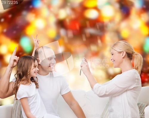 Image of happy family with camera at home