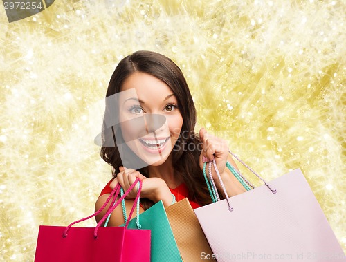 Image of smiling woman with colorful shopping bags