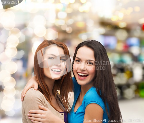 Image of smiling teenage girls hugging