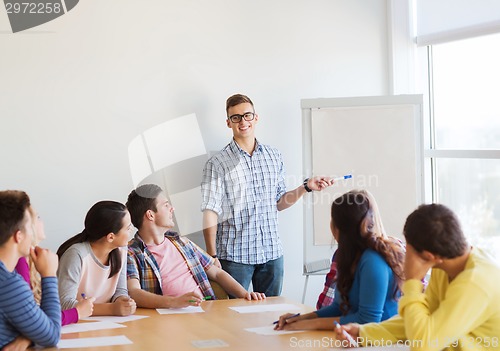 Image of group of smiling students with white board