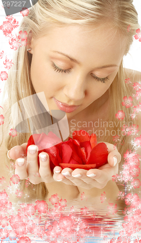 Image of lovely blond in water with red rose petals