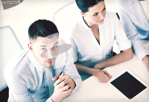 Image of serious businessman on meeting in office