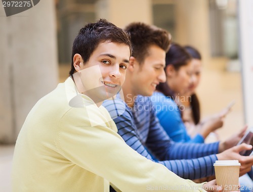Image of group of students with tablet pc and coffee cup