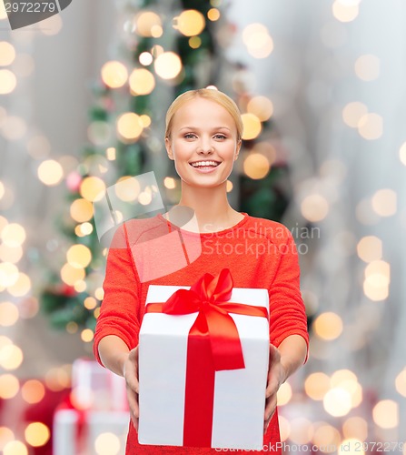 Image of smiling woman in red clothes with gift box