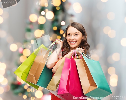 Image of smiling woman with colorful shopping bags