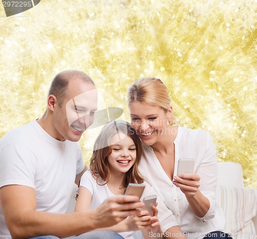 Image of happy family with smartphones