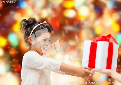 Image of smiling little girl with gift box