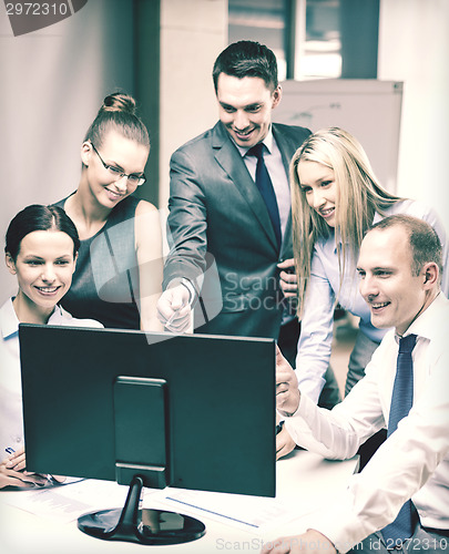 Image of business team with monitor having discussion