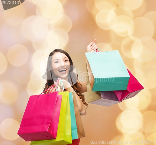 Image of smiling woman with colorful shopping bags