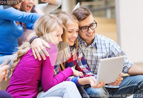 Image of group of smiling students with tablet pc