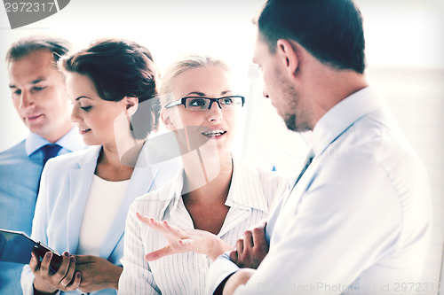 Image of man and woman having discussion in office