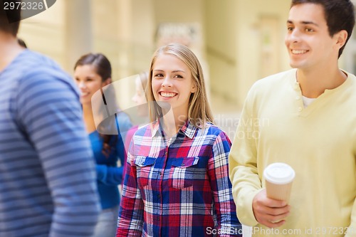 Image of group of smiling students with paper coffee cups