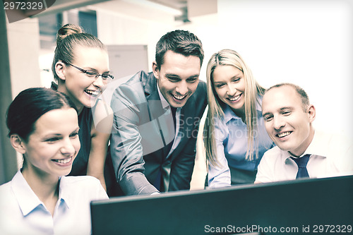 Image of business team with monitor having discussion