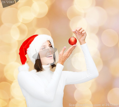 Image of woman in santa helper hat with christmas ball