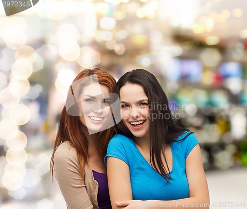 Image of smiling teenage girls hugging