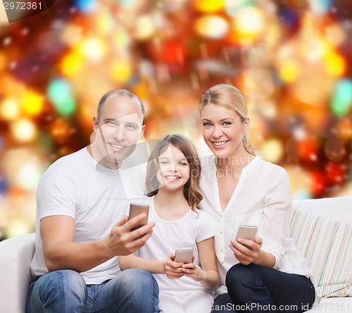 Image of happy family with smartphones